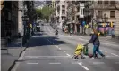  ?? Photograph: Paco Freire/SOPA Images/Rex/Shuttersto­ck ?? A woman wearing a face mask crosses a street in Barcelona. Spain has reported its lowest daily reported death toll since 26 March.