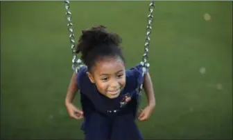  ?? JOHN LOCHER — THE ASSOCIATED PRESS ?? Six-year-old Kiina Amado sits on a swing at the McCarran Internatio­nal Child Developmen­t Center in Las Vegas.
