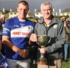  ?? John O’Leary, County Board PRO presenting, the St Brendan’s team captain Denis Moriarty with the County IHC Cup ??