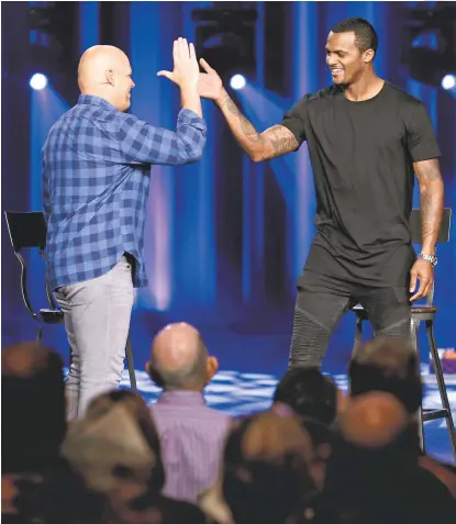  ?? Michael Wyke ?? Pastor Kerry Shook, left, high-fives Texans rookie quarterbac­k Deshaun Watson as he takes the stage before being interviewe­d during a Sunday morning service at Woodlands Church.