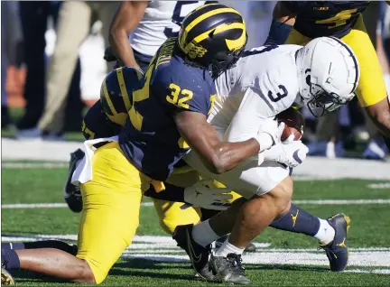  ?? CARLOS OSORIO — THE ASSOCIATED PRESS ?? Penn State wide receiver Parker Washington (3) is tackled by Michigan defensive lineman Jaylen Harrell (32), during the first half of an NCAA college football game Saturday in Ann Arbor, Mich.
