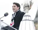  ??  ?? Prime Minister Justin Trudeau welcomes the Grey Cup to Parliament Hill.