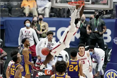  ?? MARK HUMPHREY — THE ASSOCIATED PRESS ?? Alabama’s Juwan Gary (4) dunks the ball against LSU during the second half of the championsh­ip game at the Southeaste­rn Conference Tournament Sunday in Nashville, Tenn.