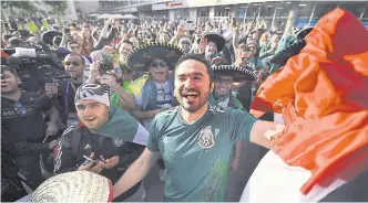  ?? HECTOR VIVAS/GETTY IMAGES ?? Mexican soccer fans celebrate in Moscow after their nation won the bid to co-host the 2026 FIFA World Cup with Canada and the United States.