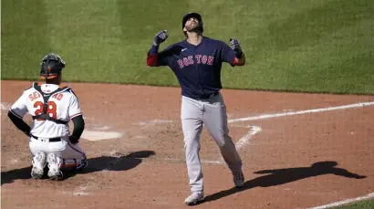  ?? Ap ?? HOT START: J.D. Martinez reacts after hitting his third home run of the game on Sunday as the Red Sox finished off a sweep of the Orioles with a 14-9 win. Below, Nathan Eovaldi has looked as good as any other pitcher in MLB through two starts. Can he be depended on to make 30 starts?