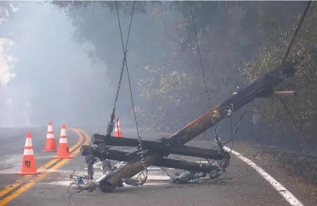  ?? Paul Chinn / The Chronicle ?? Above: A utility pole is down on Geysers Road where the Kincade Fire blazed in Sonoma County.