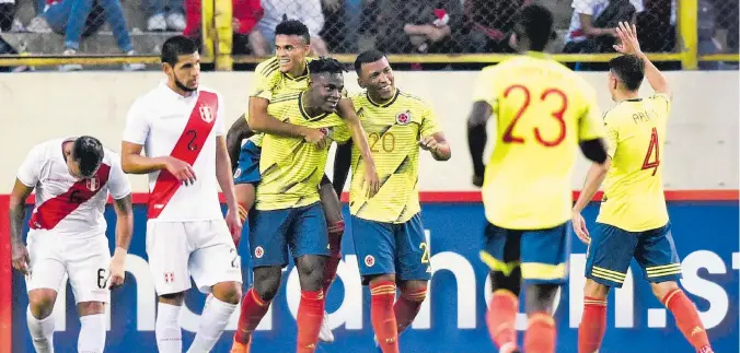  ?? AFP ?? Duván Zapata (c) celebra con Luis Díaz y Róger Martínez, entre otros jugadores de la selección Colombia, el gol que le marcó a Perú en el triunfo ‘Tricolor’ 3-0. Los peruanos lamentan lo ocurrido.