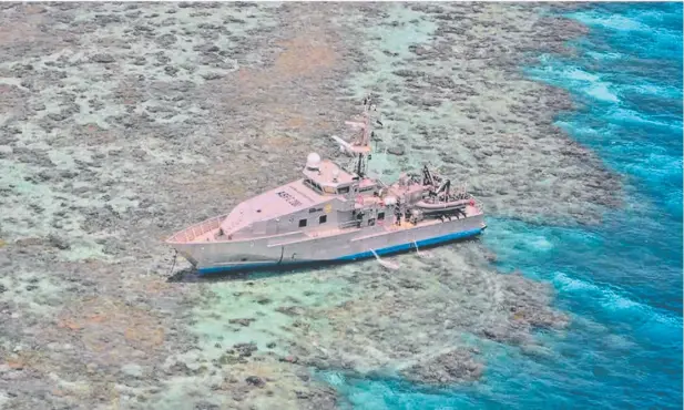  ?? Picture: AUSTRALIAN BORDER FORCE/AUSTRALIAN TRANSPORT SAFETY BUREAU ?? HIGH AND DRY: Australian Border Force patrol boat Roebuck Bay grounded at Henry Reef last year.