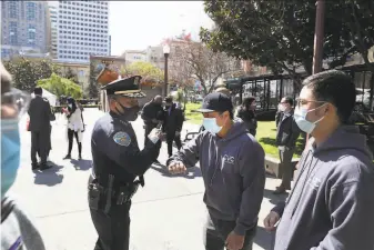  ?? Lea Suzuki / The Chronicle ?? Police Chief Bill Scott (left) said last week that his department has increased patrols in primarily Asian American neighborho­ods in San Francisco.