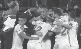  ?? MIGUEL MORENATTI, THE ASSOCIATED PRESS ?? Sevilla players celebrate after Guido Pizarro, centre, scored their third goal against Liverpool completing their three-goal comeback.