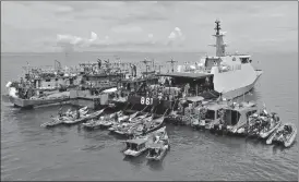  ?? AFP ?? Fishermen arrive on their boats to receive doses of Sinovac’s Covid-19 vaccine on board an Indonesian navy ship off the coast of Riau.