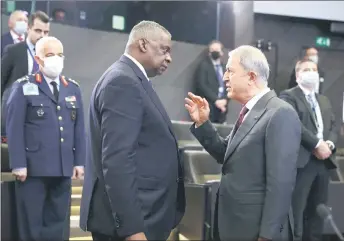  ?? — AFP photo ?? Austin (left) and Turkish Defence Minister Hulusi Akar speak on the second day of a Nato Defence Ministers meeting in Brussels.