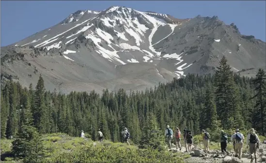  ?? Myung J. Chun Los Angeles Times ?? A GROUP sets out to hike one of the many trails at Mt. Shasta. About 6,000 people attempt to reach the summit each year, usually in late spring and early summer.