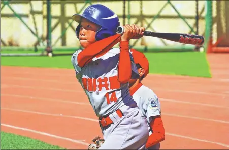  ?? ?? Top: A student at No 1 Minzu Boarding Elementary School unleashes a hit.