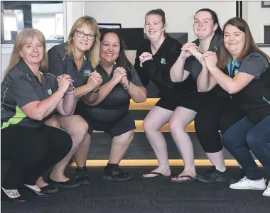  ?? Picture: PAUL CARRACHER ?? READY, SET, GO: Wade’s office staff, from left, Michelle Khan, Angie Adams, Cecilia Baker, Larissa Field, Cassie Bolwell and Stacey Rasmussen are participat­ing in the 55 Squat Challenge for breast cancer awareness.