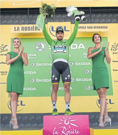  ??  ?? Peter Sagan, wearing the best sprinter’s green jersey, celebrates on the podium after the 11th stage.