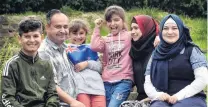  ?? PHOTO: PETER MCINTOSH ?? Proud Kiwis . . . Showing off their new flag are the Haroura family, (from left) Ousama (14), Mohamad, Lina (8), Rahaf (10), Nawal, and Waafa (17).