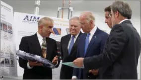  ?? SHAWN DOWD — DEMOCRAT & CHRONICLE VIA AP ?? Alain Kaloyeros, president of SUNY Polytechni­c Institute, left, and Michael Liehr, executive vice president of innovation and technology, of SUNY Poly, right, brief Vice President Joe Biden, center, New York Governor Andrew Cuomo, second from right,...