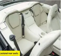  ??  ?? Soft-top roof folds electrical­ly under a tonneau behind the two occasional rear seats