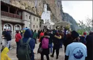  ?? (AP/Risto Bozovic) ?? People wait in line Tuesday in front of the Christian Orthodox monastery of Ostrog, Montenegro.