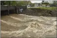  ?? DOMINIC GWINN — HATTIESBUR­G AMERICAN VIA AP ?? Water from Gordons Creek rushes under the Bay Street bridge in downtown Hattiesbur­g, Miss., following heavy storms on Tuesday.