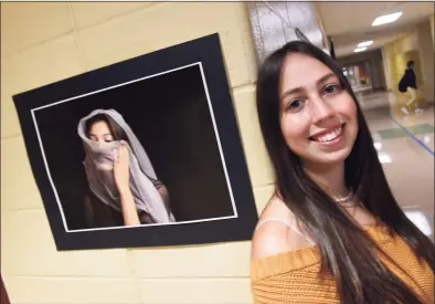 ?? Arnold Gold / Hearst Connecticu­t Media ?? North Haven High School senior Zoey LoPresti is pictured on Wednesday with a photograph she took as a sophomore of classmate, Aubrey Reyes, that won a Congressio­nal Art Award and hangs in the Capitol Building in Washington, D.C.