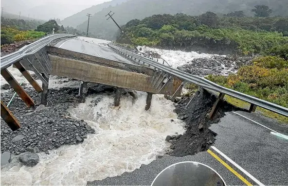  ?? NICK DEMPSEY THE COASTERS CLUB ?? The approach to Goat Creek bridge, near Otira on SH73 between the West Coast and Arthur’s Pass, was damaged by yesterday’s deluge. Left: Raging floodwater yesterday in the Hokitika Gorge on the West Coast.