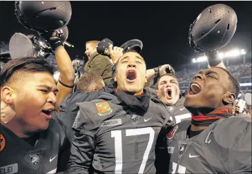  ?? AARON P. BERNSTEIN / GETTY IMAGES ?? Ahmad Bradshaw (center) and his Army teammates celebrated last year after the Black Knights defeated Navy to end a 14-season losing streak in the rivalry. The teams meet for the 118th time Saturday.