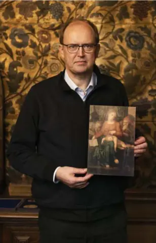  ?? verdwenen schilderij. ?? Pastoor Jan Van Raemdonck met een afbeelding van het