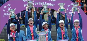  ?? (AFP) ?? US players celebrate with their trophy after winning the Fed Cup final against hosts Belarus in Minsk on Sunday
