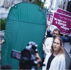 ?? (Courtesy T’ruah) ?? RABBIS ASSOCIATED with T’ruah: The Rabbinic Call for Human Rights carry a pop-up sukka in a protest for immigrants’ rights outside Trump Tower in Manhattan on Monday.