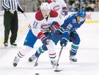 ??  ?? Canadiens winger Brendan Gallagher tries to fend off Canucks centre Brendan Gaunce during first-period action in Vancouver on Tuesday.