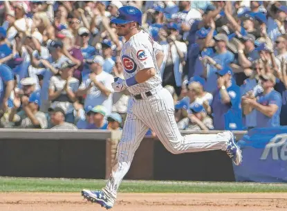  ??  ?? Ian Happ circles the bases after hitting a home run in the fourth inning Saturday against the Blue Jays. | DAVID BANKS/ GETTY IMAGES