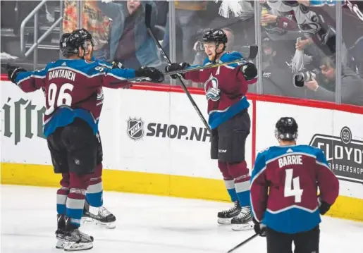  ?? Andy Cross, The Denver Post ?? From left, Avalanche right wing Mikko Rantanen, left wing Gabe Landeskog and center Nathan MacKinnon celebrate MacKinnon’s second goal of the game early in the second period Monday night against the Predators. Colorado’s 5-3 win cut its series deficit...