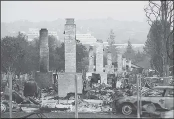  ?? ASSOCIATED PRESS FILES ?? A row of chimneys stand in a neighborho­od devastated by the 2017 Tubbs fire near Santa Rosa. A trust representi­ng more than 80,000 victims of deadly wildfires ignited by Pacific Gas and Electric’s rickety electrical grid is suing nearly two dozen of the utility’s former executives and Board members for alleged derelictio­n of their duty to ensure the equipment wouldn’t kill people.