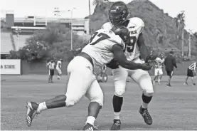  ?? SAM CARAVANA/AZCENTRAL SPORTS ?? Defensive lineman Shannon Forman (97) runs through a block during practice on Aug. 10.