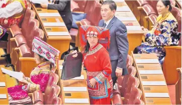  ??  ?? This file photo shows delegates, some wearing ethnic minority outfits, arriving at the opening of the 19th Communist Party Congress at the Great Hall of the People in Beijing. — AFP photo