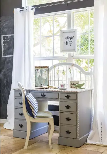  ??  ?? Love the farmhouse DIY look? Transform an old flea-market desk into your workspace with a bit of paint, like homeowner Desiree Guy did here. This will help your desk area blend into the rest of your home, especially if you don’t have a full room to use as a home office.