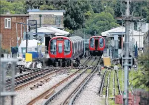  ?? AP PHOTO ?? A police forensic tent stands setup on the platform next to the train, at left, on which a homemade bomb exploded at Parsons Green subway station in London, England,Friday.