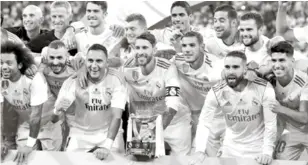  ?? AP ?? Jugadores del Real Madrid posan con el trofeo de campeón tras conquistar la supercopa, tras derrotar al Barcelona.