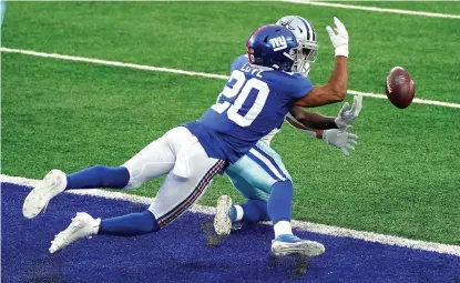  ?? AP Photo/Corey Sipkin ?? ■ New York Giants’ Julian Love (20), left, breaks up a pass in the end zone intended for Dallas Cowboys’ Michael Gallup during the second half Sunday in East Rutherford, N.J.