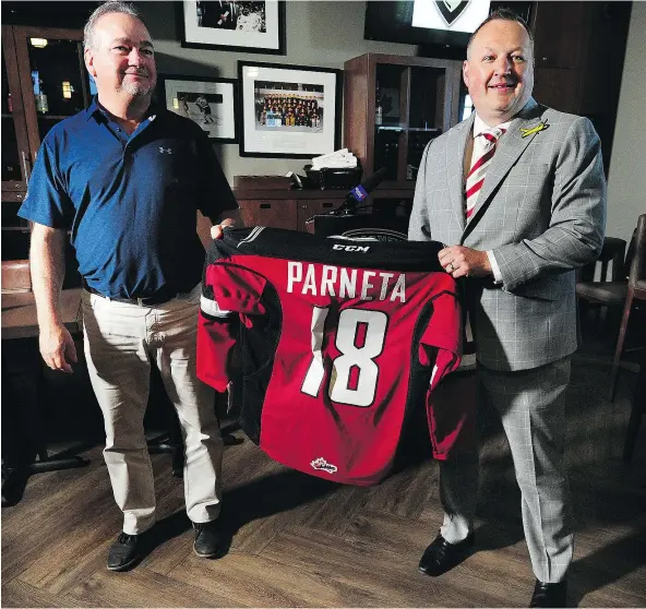  ?? NICK PROCAYLO ?? Barclay Parneta talks to media with Peter Toigo, left, after being named the new GM of the Vancouver Giants on Wednesday. ‘We want to be competing for championsh­ips,’ says Parneta. ‘It’s more than just getting into the playoffs.’