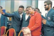  ?? PTI ?? Former Indian cricketer Ajay Jadeja poses for a selfie with players of the Indian cricket team for blind on Thursday.