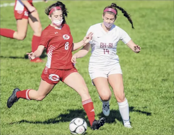  ?? James Franco / Special to the Times Union ?? Guilderlan­d midfielder Riley Grimm gets a foot on the ball in front of Burnt Hills forward Chelsea Speranza during a Suburban Council matchup at Guilderlan­d. The Lady Dutch had only scored four goals over their past four games, so the outburst came at a most welcome time.