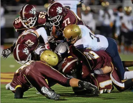  ?? PHOTOS BY TANIA BARRICKLO — DAILY FREEMAN ?? Kingston’s defense takes down Newburgh’s Bobby Randall in the second quarter of Tigers’ loss to Goldbacks.