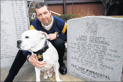  ?? KYLE TELECHAN/POST-TRIBUNE 2017 ?? Officer Joe Hamer poses for a photo with his police dog, Bruno, near the Lake County Canine Memorial at the Lake County Sheriff's Department in Crown Point in 2017.