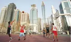  ?? Gulf News Archives ?? Young Filipinos enjoy a basketball game in Satwa park.