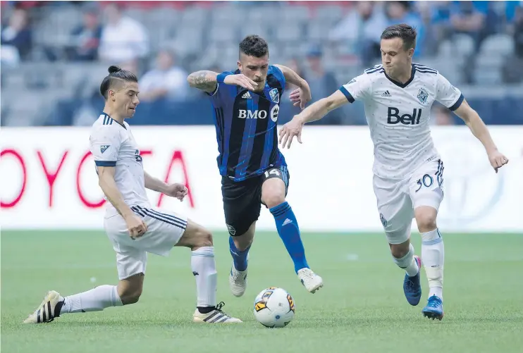  ?? — THE CANADIAN PRESS FILES ?? Montreal Impact’s Adrian Arregui moves the ball between Whitecaps’ Nicolas Mezquida, left, and Ben McKendry on May 23 in Vancouver.