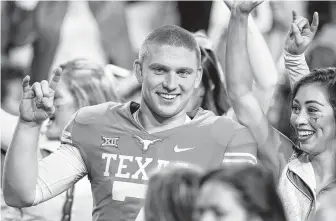  ?? Tim Warner / Getty Images ?? Shane Buechele celebrates after completing 10-of-10 passes in his final action for Texas in a 24-10 win over Iowa State last year. Because he only played in two games in 2018, he’s a junior at SMU.