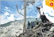  ?? AFP PHOTO / NEPAL ARMY ?? Nepalese residents stand near damaged houses after a landslide in the northeaste­rn district of Sindhupalc­howk.